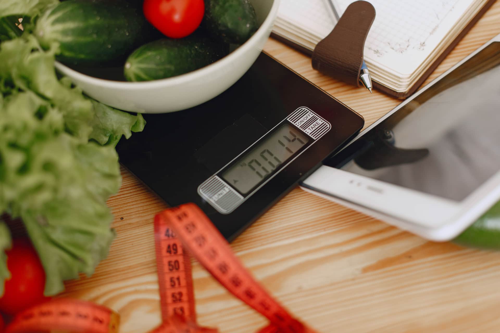 A notebook and measuring tools on a wooden work surface