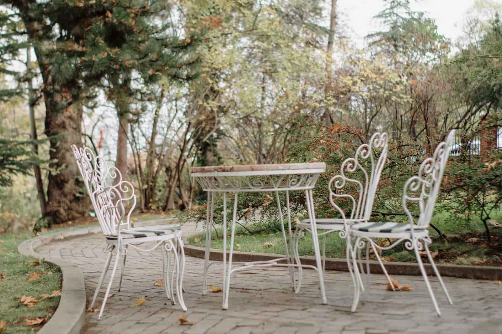 Patio chairs and a table on a stone terrace in autumn light